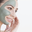 Sole Peloid Mud Mask (4 Pack) right-facing profile of white woman with face half covered with mud mask against white background