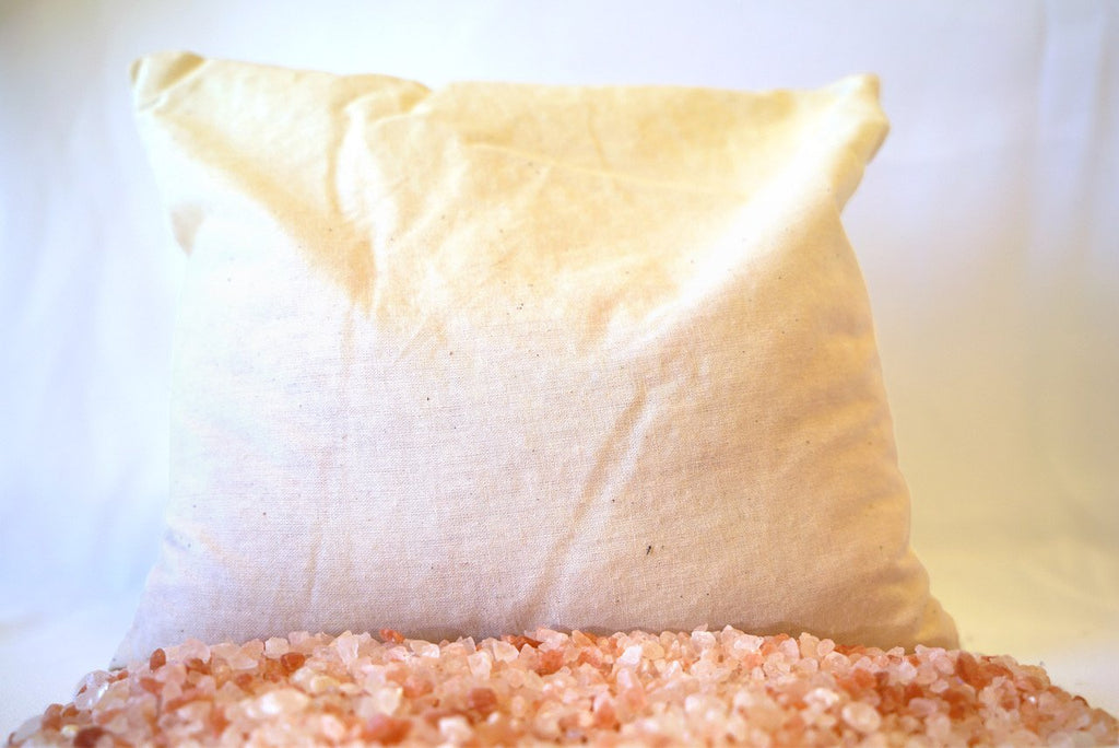 Salt Sachet off-white sachet resting on pile of coarse himalayan crystal salt